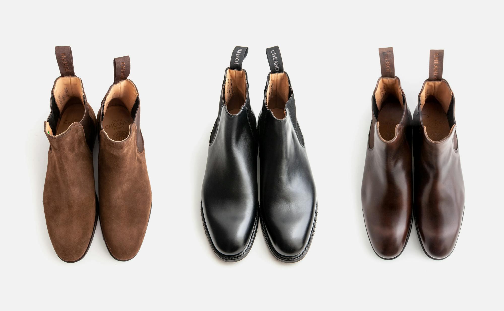 Three pairs of Cheaney Godfrey boots, one in brown calf, one in black calf, and the last in brown suede.