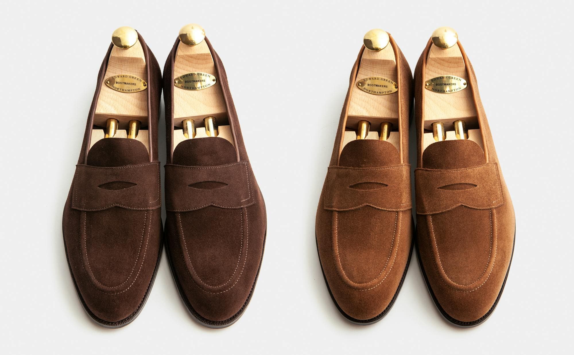 A pair of mink suede Edward Green Picadilly loafers next to a pair of raw umber suede Edward Green Picadilly loafers.